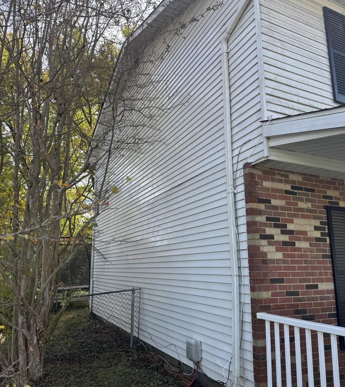 Clean white siding on the side of a two-story home