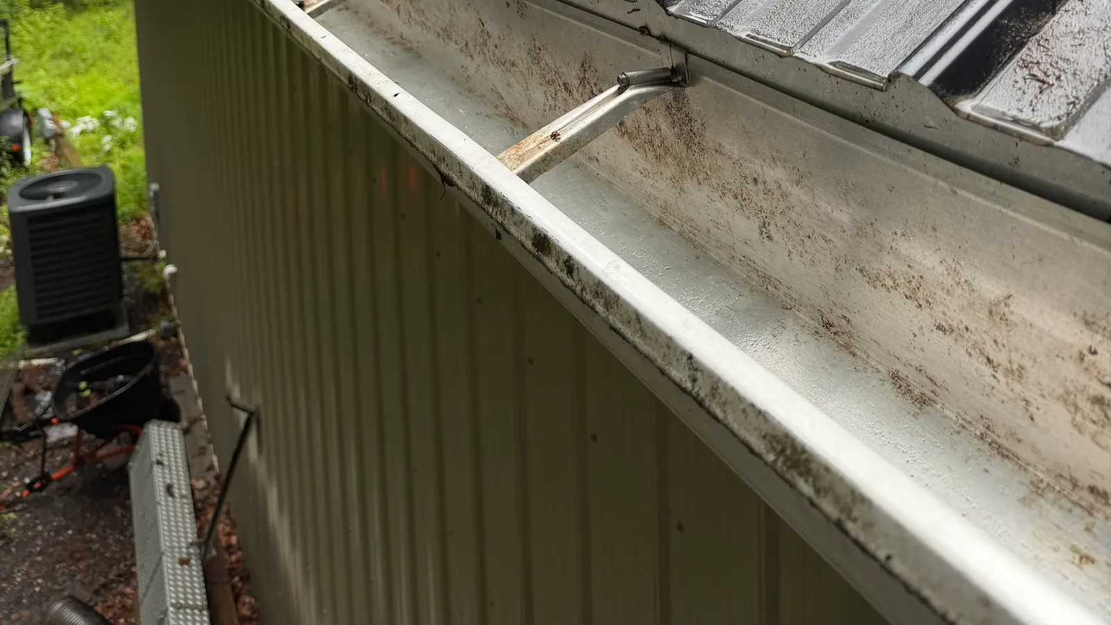 A cleared gutter along the edge of a metal roof
